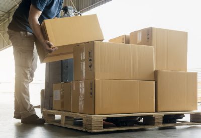 Worker courier lifting shipment boxes stacking on pallet, packaging. cardboard box, warehouse delivery service shipment goods, manufacturing warehouse.